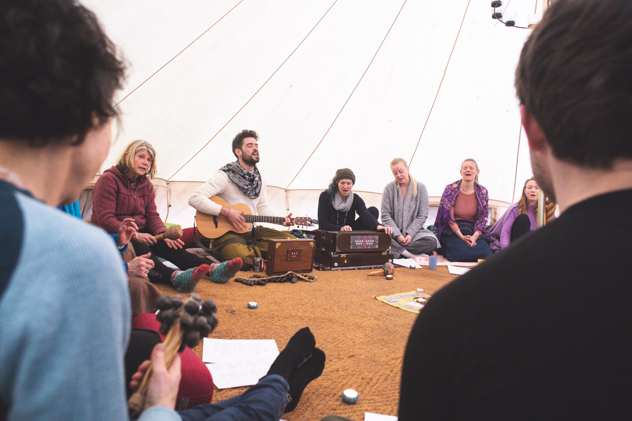 Group mantra singing circle in a tent